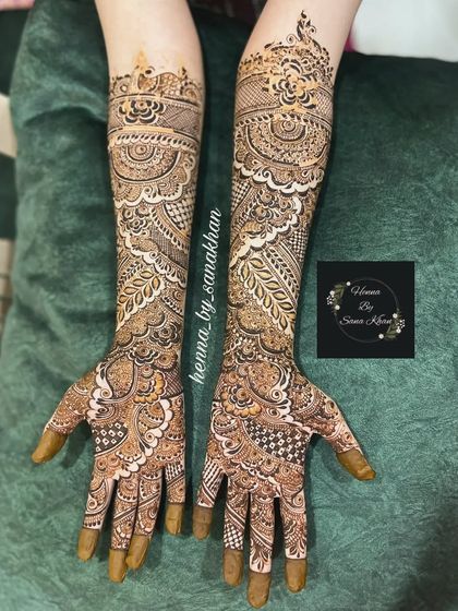 A beautiful example of a full-arm bridal design with leafy vines and paisley elements, creating a soft and elegant flow.