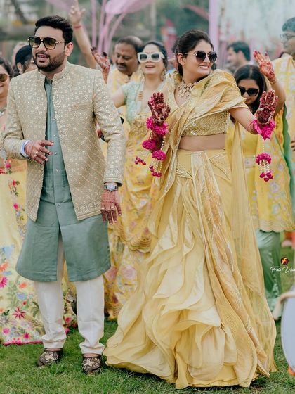Rajat and Kriti dancing with their guests at their outdoor Haldi. We focus on capturing the movement and energy of the celebration in a beautiful, natural setting.