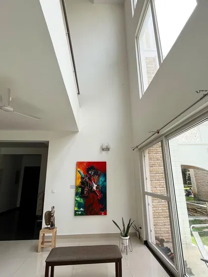 Our gallery is a 7,000 sq ft modern space with high, light-filled ceilings, designed to let large-scale artworks breathe. This piece, a vibrant portrait of Jimi Hendrix, shows how the architecture itself becomes part of the viewing experience.