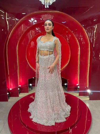 If there was an Indian Barbie dress, this would be it. This silver and pink fish-cut lehenga with attached cape sleeves is a modern fairytale outfit. It's perfect for a reception or engagement party.