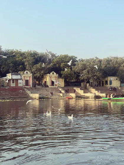 A view of the historic ghats and small temples that line the banks of the Yamuna River, seen from our boat.