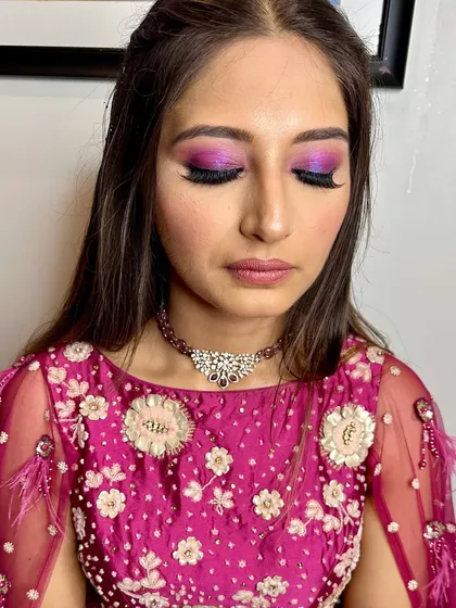 A close-up of the dramatic purple eye makeup, perfect for a night of dancing and celebration.