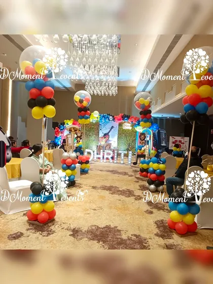 The walkway into the musical party, lined with tall balloon pillars topped with clear balloons filled with smaller, colorful ones.