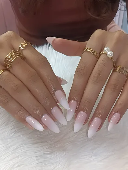 Soft, elegant, and absolutely timeless. These dreamy baby pink ombré nails on a sharp stiletto shape are perfect for the romantic bride who loves a subtle yet stunning look.