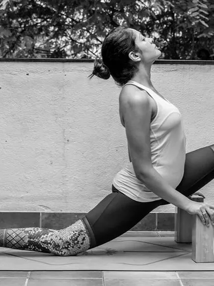 In this low lunge, or Anjaneyasana, blocks under the hands provide lift and stability. This modification helps you to sink deeper into the hip stretch while keeping the chest open and spine long.