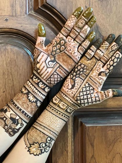 A gorgeous semi-bridal design with peacocks, elephants, and lotus motifs. It provides significant coverage without being a full bridal, ideal for a sangeet or reception.