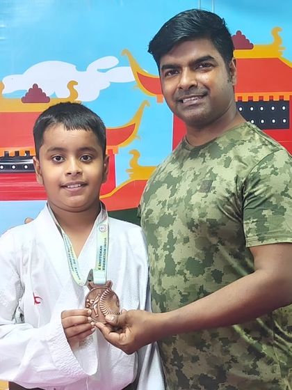 Celebrating a bronze medal win at the Open National Karate Championships. Every medal represents countless hours of dedication.