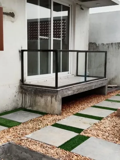 I love creating modern, clean looks by combining different materials. This pathway uses a mix of stone pavers, natural pebbles, and strips of artificial grass for a stylish, low-maintenance design that adds character to any outdoor area.