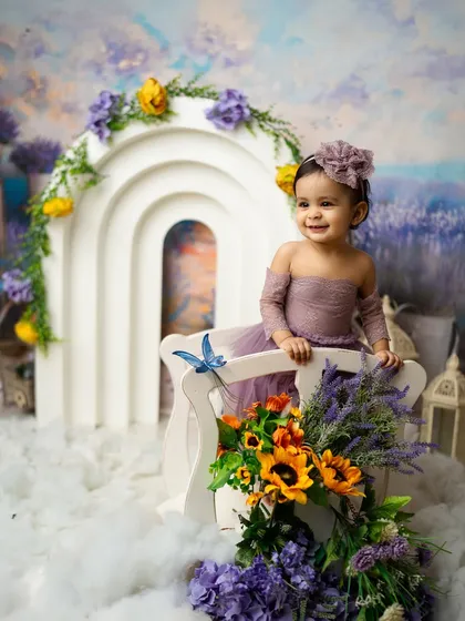 A beautiful smile from a little girl in a lavender field. This floral-themed milestone shoot is full of dreamy colors and happy moments.