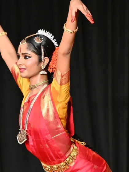 A dynamic pose from Anvita Jain's arangetram, showcasing the blend of strength, flexibility, and artistry that defines a skilled Bharatanatyam dancer. This is a moment of pure, uninhibited expression.