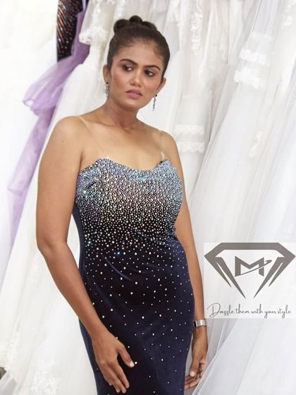 I call this my midnight sparkle gown. The rich navy velvet is hand-embellished with crystals in a dazzling ombré effect, like a starlit sky. The strapless design is both classic and captivating.