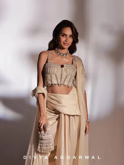 A beautiful portrait of Diipa Buller Khosla in the Alauren Set, holding an embellished clutch that perfectly complements the intricate beadwork of the corset.