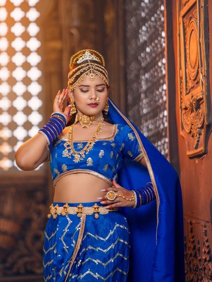 A full view of the majestic blue outfit and jewellery. This is a perfect example of the kind of unique, high-fashion looks you can create with our rental pieces.
