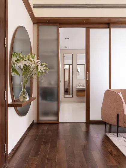 A view of the primary room in 'A Walk in the Clouds', showing the frosted glass sliding doors that lead to the luxurious master bathroom.