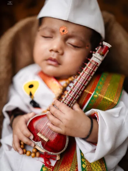 A tribute to our rich traditions. This little one is styled as a Varkari, complete with a miniature sitar, capturing a moment of pure, divine sleep. I take pride in creating these unique cultural themes.