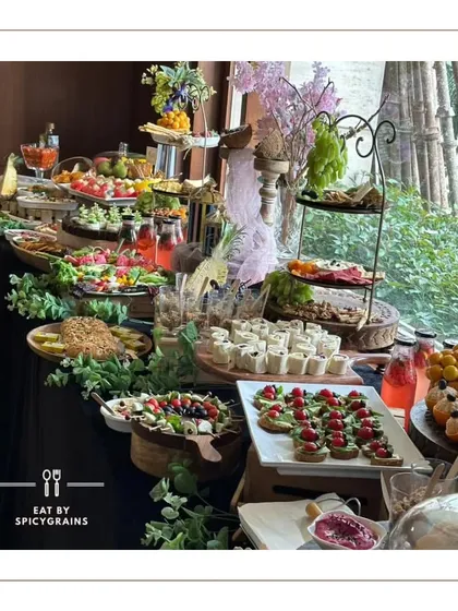 This grazing table, set against a black tablecloth, allows the vibrant colors of the food to truly pop. We incorporated fresh greenery and elegant serving ware to create a sophisticated look for a private celebration.