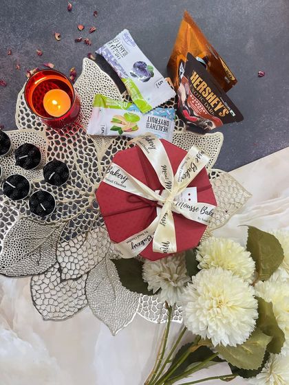 A glimpse of one of my compact Diwali hampers. This festive red box is filled with assorted chocolates and dry fruit bars, and comes with decorative candles to light up the celebration.