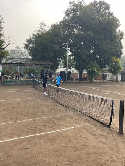 The spirit of competition and sportsmanship on display. A moment of respect between players at the net during the NPPL league selection matches in Nashik.