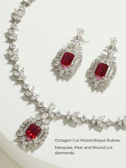 A product shot of the Ruby Dynasty Set, detailing the octagon-cut Mozambique rubies and the surrounding marquise, pear, and round-cut diamonds.