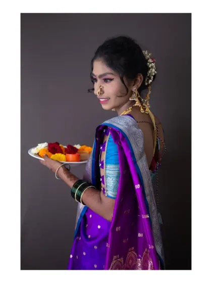 Another angle from our traditional Maharashtrian shoot. This side profile captures the elegance of the nath (nose ring) and the delicate details of the jewelry, set against a clean, dark background to emphasize the subject.