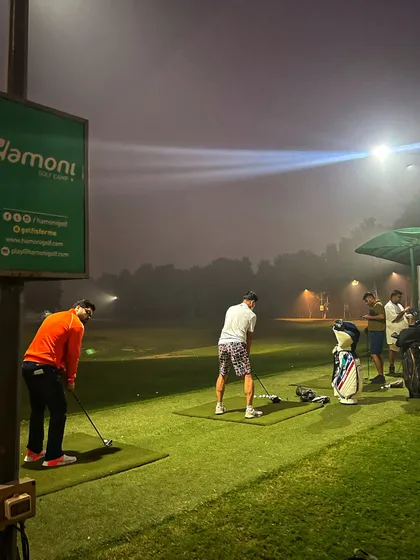 A foggy night on the range, with the floodlights cutting through the mist for a unique practice experience.