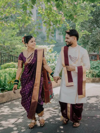A happy, candid shot of the couple walking hand-in-hand, sharing a smile. This image feels full of life and movement, capturing the joy of their journey together.