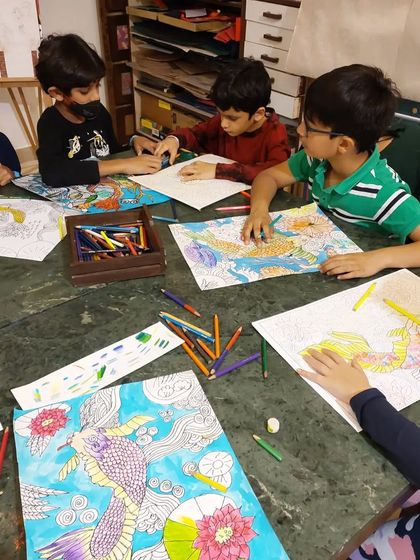 A group of boys collaborating and sharing tips as they work on their Japanese art pieces. The community aspect of my classes encourages peer learning and friendship.