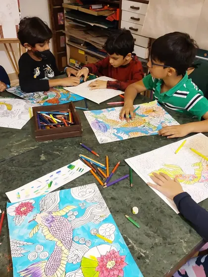 A group of boys chatting and working together on their Japanese art projects. The class is a great social and creative outlet.