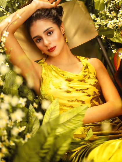 A lush, green garden with white flowers, created with projection. This technique allows me to frame the model within the foliage, creating a sense of depth and a natural, organic feel.