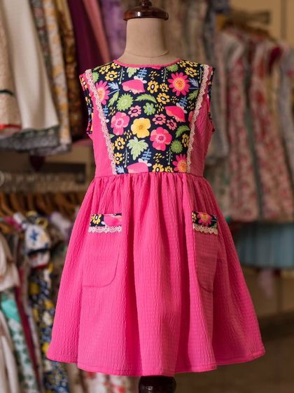I love bold combinations, like this bright pink dress with a vibrant floral bodice. The matching floral print on the pockets is a fun, thoughtful detail.