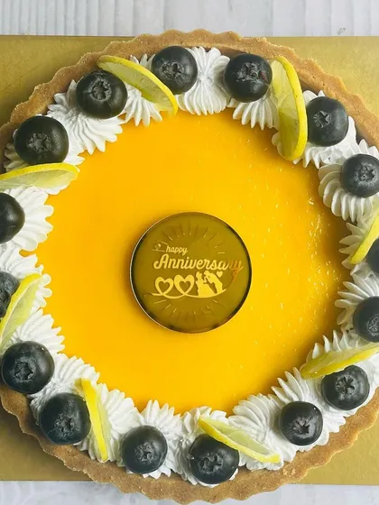 A bright and zesty Lemon and Blueberry Tart, perfect for an anniversary. The tangy lemon curd is balanced by sweet blueberries and creamy whipped topping.