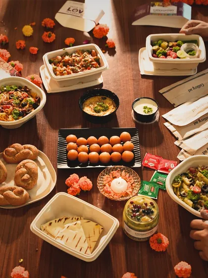Planning a party? Let me handle the food. This is the kind of spread you can expect, a full table of delicious and healthy options. From pastas and salads to Indian sweets and pita bread with hummus, there's something for everyone.