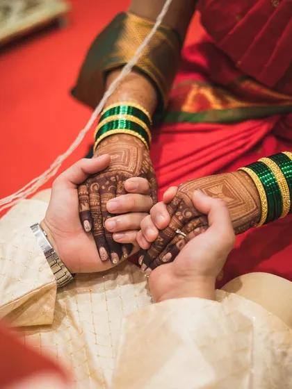 A close-up of the couple holding hands during a wedding ritual.