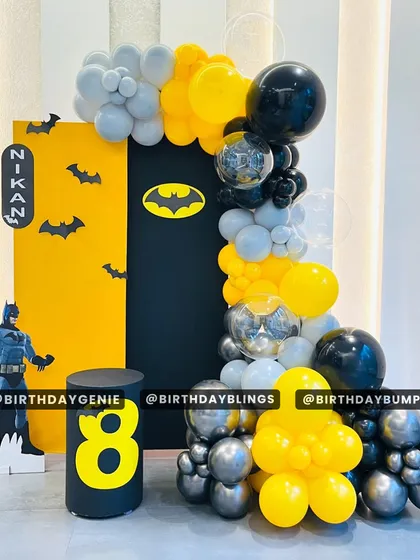 A sleek and modern Batman-themed party for an 8th birthday. The black and yellow color scheme, bat-symbol backdrop, and character cutout create a cool, graphic look.