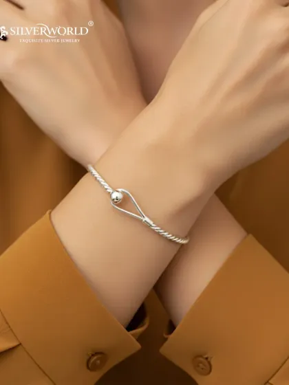 Our sterling silver Cape Cod bracelet is a bestseller for a reason. Its elegant, minimalist design with the iconic ball clasp makes it a perfect accessory for daily wear, easily transitioning from a professional setting to a casual evening out.
