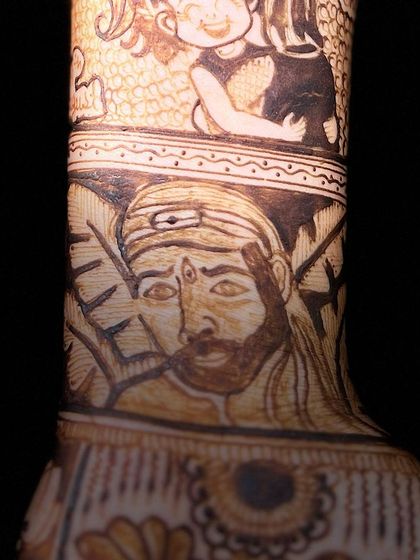 A detailed shot of a Sai Baba portrait requested by the bride. The ability to create recognizable and respectful portraits of divine figures is a skill I have honed over many years.