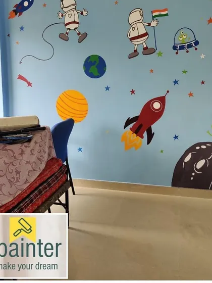 A playful, hand-painted space-themed mural perfect for a child's bedroom. The design includes astronauts, rockets, planets, and friendly aliens on a light blue background to spark imagination.