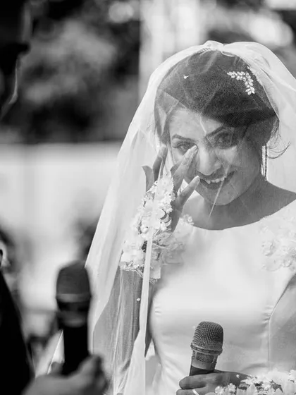 Tears of joy while exchanging personal vows. This black and white photo focuses on the bride's emotional expression, highlighting the sincerity of the moment.