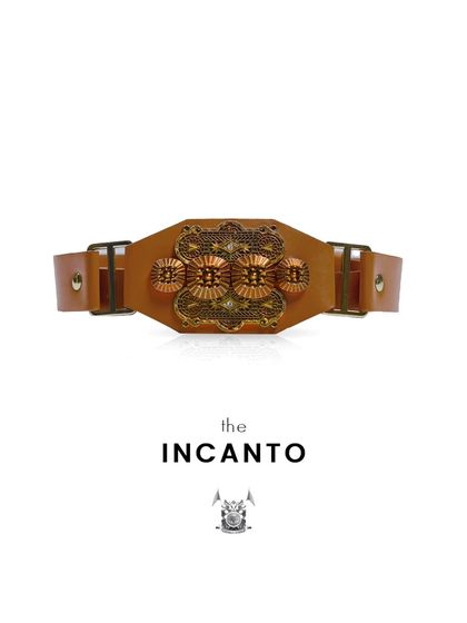 This is the 'Incanto' belt, which means 'enchantment'. It is a handcrafted leather belt with an ornate metal buckle, designed for those who wear confidence like a charm.