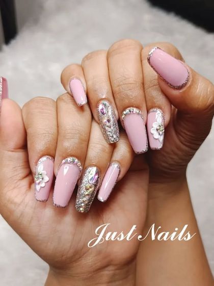 A sophisticated bridal or party look. This design features long, coffin-shaped nails in a soft pink, accented with silver glitter, 3D flowers, and rhinestone details.