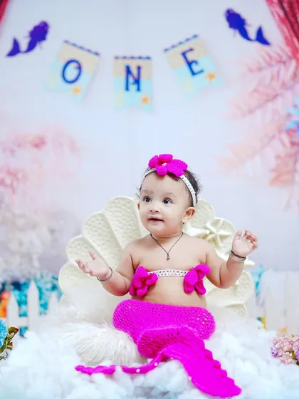 Looking up with wide-eyed wonder, this baby girl is the star of her own underwater fairytale.