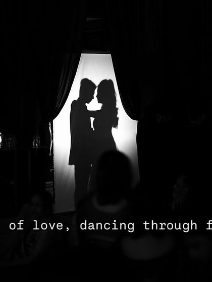 A simple yet powerful silhouette shot to start a couple's performance. It creates a sense of intimacy and anticipation before the lights come up, telling a story of love in the shadows.