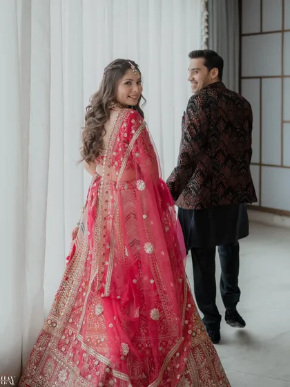 A candid, "follow me" style shot. The bride looks back with a beautiful smile while leading the groom, creating a sense of adventure and playfulness in their journey together.