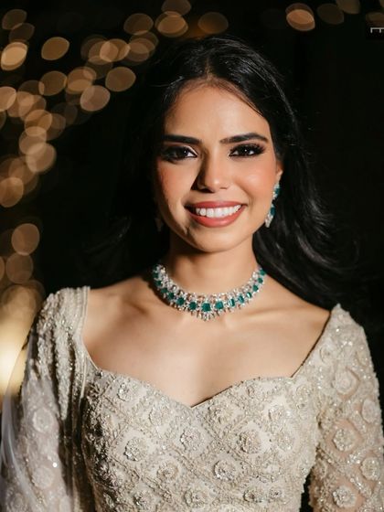 A glamorous evening look in a white ensemble. The smokey eye and radiant skin create a look that is perfect for a reception or cocktail party.