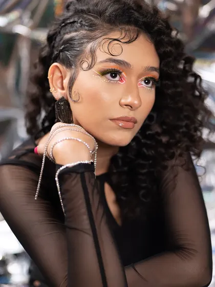 The art of eye contact. This editorial look features a neon graphic liner on a curly-haired model, creating a modern, edgy, and high-fashion aesthetic.