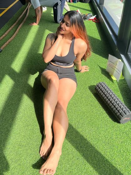 A candid moment of smiling and relaxing on the gym turf. It's important to find joy in the journey.