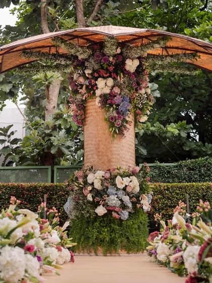 The stunning floral-adorned backdrop for the engagement, which was handmade by 18 women weavers from North Karnataka.