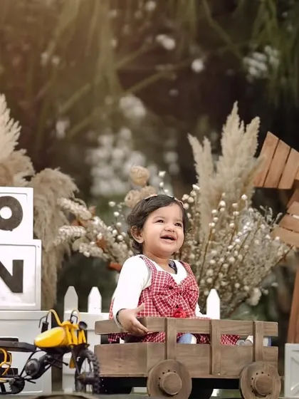 A joyful smile from the birthday boy. His happiness is contagious in this fun, rustic-themed first birthday photoshoot.