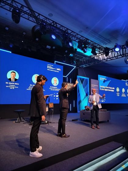 Our team setting up the stage for a panel discussion at the SAP NOW AI Tour. We ensure the layout is perfect for both the panelists and the audience view.