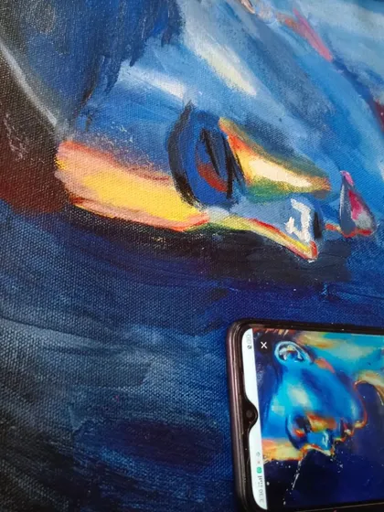 This image captures the process of creating a vibrant, abstract portrait, focusing on bold color choices and brushstrokes.